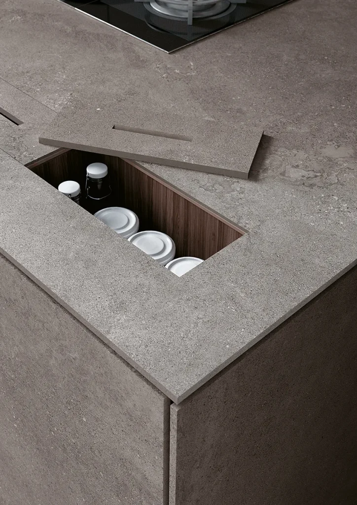 Gri, beton efektli Infinity Buxy Select porselen tezgah ve entegre gizli saklama bölmesi.