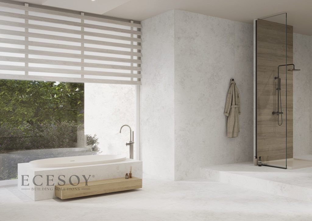 Lapidura Jura White porselen ile kaplanmış modern banyo. Açık gri, beton dokulu yüzeyler duvar, zemin ve küveti kaplıyor.